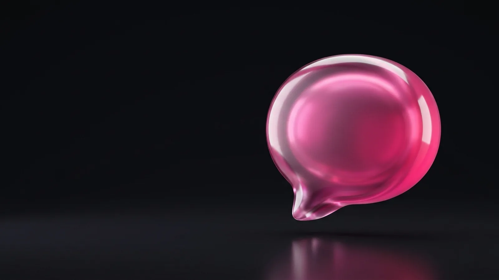 A glossy pink chat bubble on a dark background